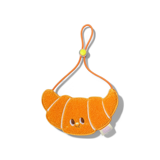 Orange croissant-shaped dog bib for small dogs and cats on white background